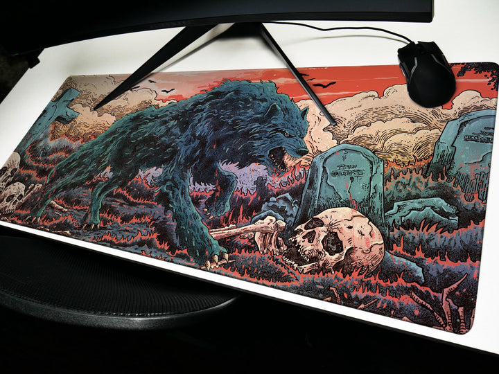 a computer mouse pad with a picture of a monster attacking a skull