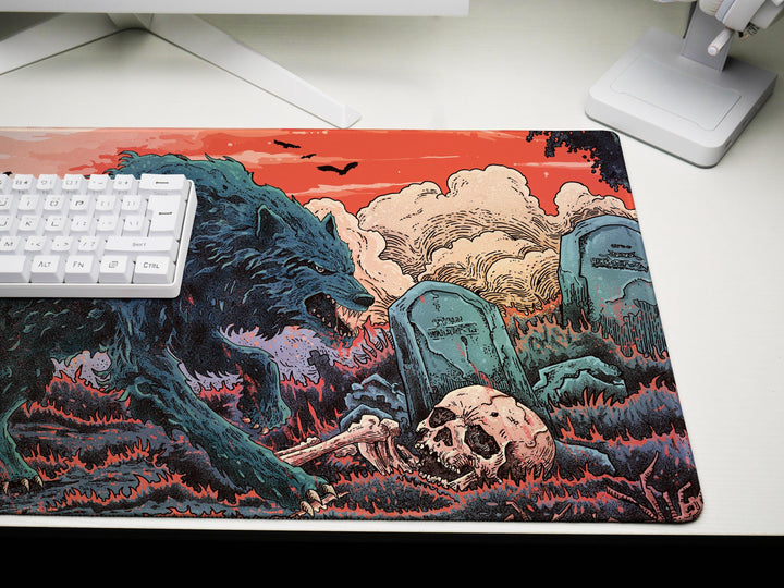 a computer mouse pad with a picture of a monster attacking a human skull